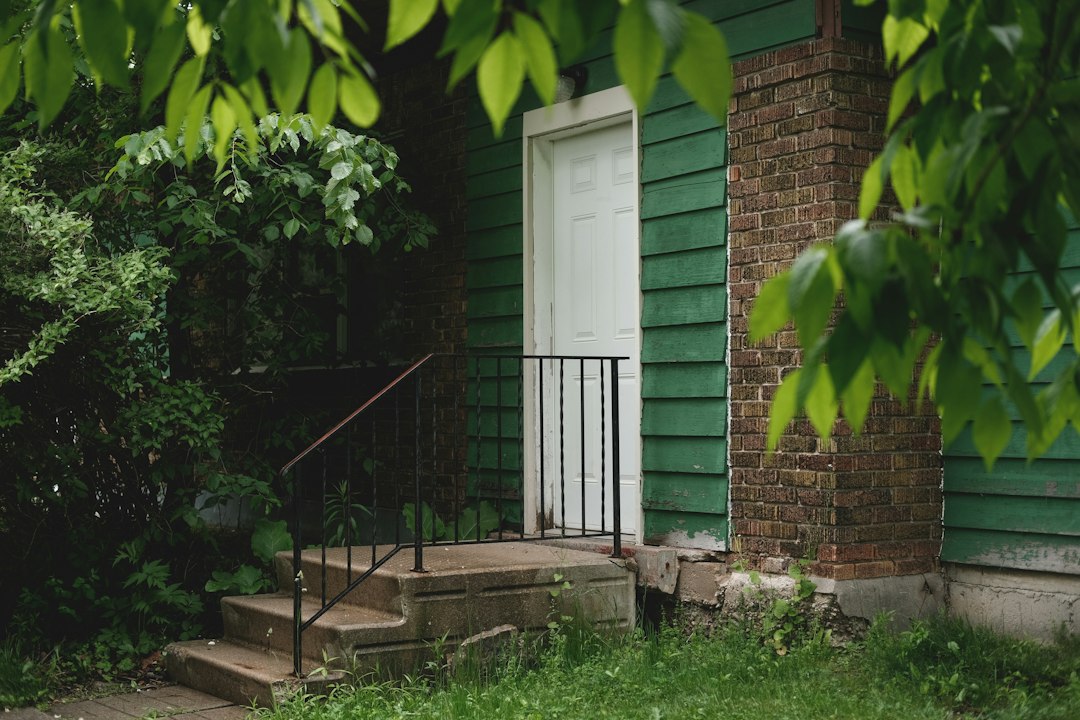 Home entrance with concrete steps and landscaping
